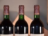 three bottles of wine are lined up on a table