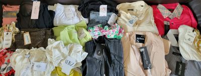 a lot of clothes that are sitting on a couch