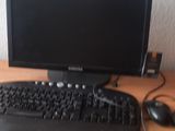 a keyboard, mouse, and monitor on a desk