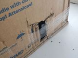 a cardboard box with a hole in it sitting on a table