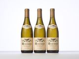 three bottles of wine sitting next to each other on a table