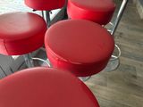 four red stools that are sitting on the floor