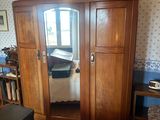 a bedroom with a bed, dresser, mirror, and other furniture