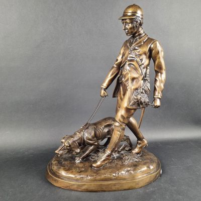 bronze statue of a man with a dog on a leash