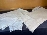 a bed with a white blanket on it and a white blanket on top of it