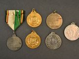 several medals and medals are displayed on a black surface