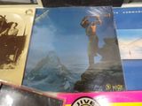 a lot of cds on a table with a picture of a man on top of a mountain