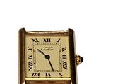 an image of a gold watch with roman numerals on the face
