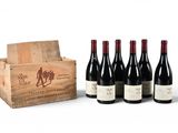 six bottles of wine in a wooden crate with a box of wine in the background
