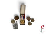 a small box with coins and a medal on it