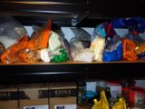 many bags of food on a shelf in the kitchen