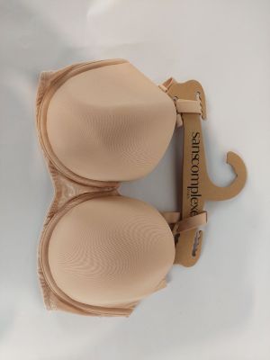 nude colored bras on display on a white surface with a wooden hanger