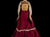 an image of a doll of a woman in a red and white dress