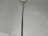 a silver spoon with a flower on it on a table