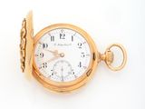 a gold pocket watch with roman numerals on it