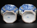 pair of chinese blue and white vases with figures on them