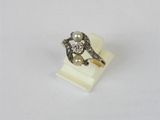 a close up of a diamond and pearl ring on a white surface