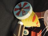 a wooden toy that is sitting next to a pair of scissors