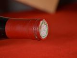 a bottle of wine on a table with a red cloth