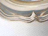a silver plate with a wave design on it