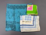 a close up of three different colored towels on a table