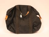 an image of a black bag with a brown handle