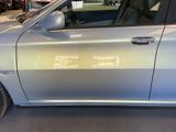 a silver car that is parked in a garage