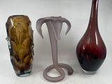 three vases sitting next to each other on a white surface