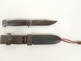 two knifes that are sitting next to each other on a white surface