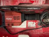 a drill in a red box with a cord