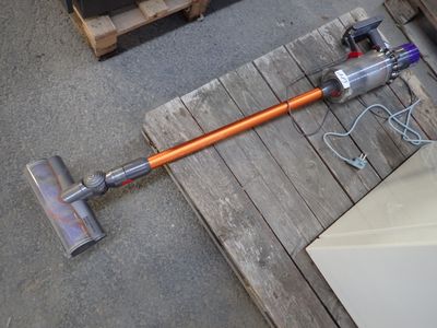 a corded vacuum that is on the floor
