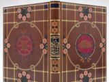 un livre marron orné de fleurs roses sur un fond blanc