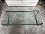 a glass coffee table on the floor in the living room