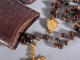 a rosary and a book on a table