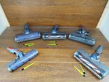 several vacuums are lined up on a wooden floor in a room