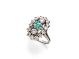 an emerald and diamond cluster ring