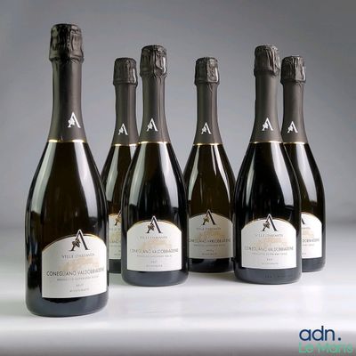 six bottles of champagne are lined up on a table