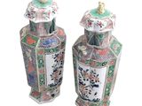 pair of chinese vases with floral designs on them on a white background