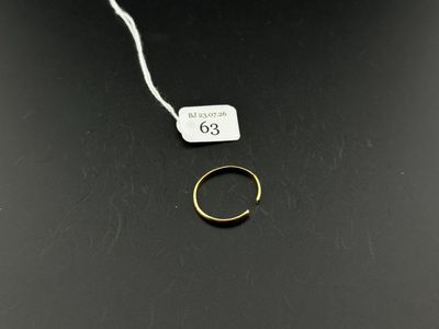 an image of a gold ring on a black surface