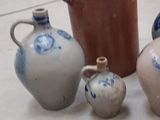 a group of vases sitting on the floor next to each other