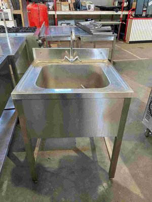 stainless steel sinks in a warehouse with a lot of other equipment