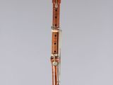 a clarinet with a wooden case on a clear surface