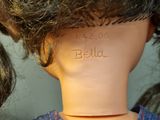 a close up of a doll ' s head with hair in it