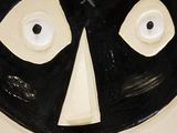 a black and white plate with a face on it