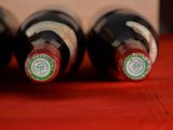 several bottles of wine are lined up on a red table