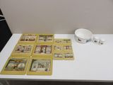 a lot of cards on the table and a bowl on the table