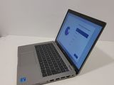 a laptop computer sitting on a table with a blue screen