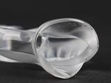 a close up of a clear glass object on a black surface