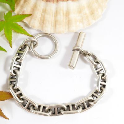 a close up of a silver chain bracelet with a clasp