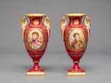 pair of red and gold vases with images of jesus and mary on them
